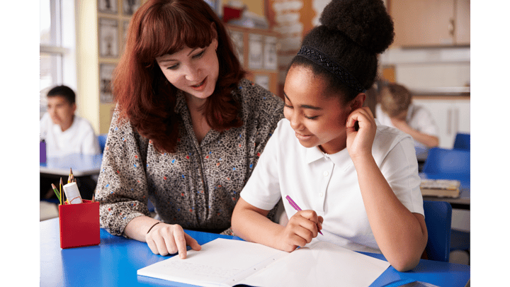 Teacher helping a child with their SATs revision